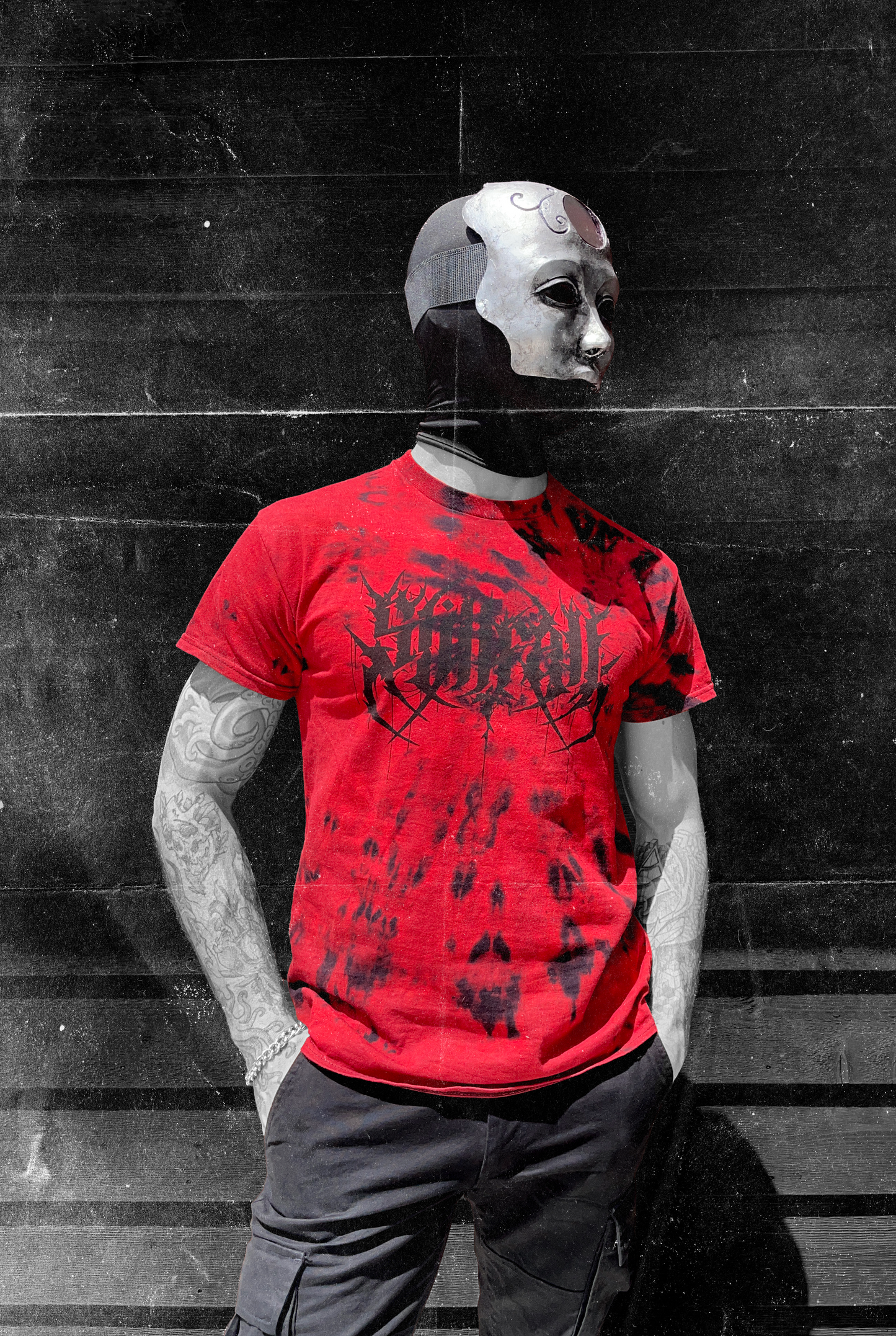 Model wearing a red & black tie-dye shirt featuring a black Stillfall logo